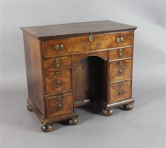 An early 18th century walnut kneehole desk, W.2ft 10in. D.1ft 6in. H.2ft 6in.